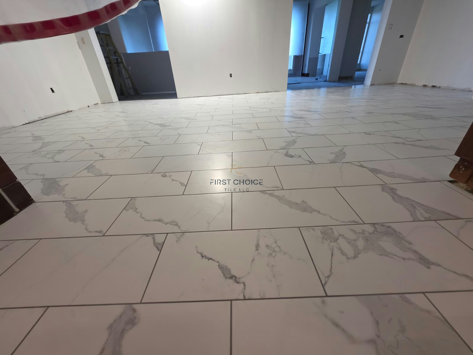 Completed 12x24 porcelain tile installation across the remodeled lobby.